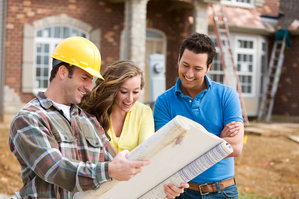 Young couple with home building contractor